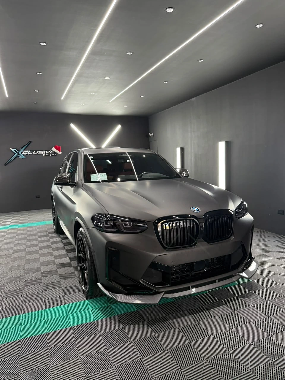BMW iX3 con vinil gris mate en el estudio Xclusive, frente, con el logo de Xclusive